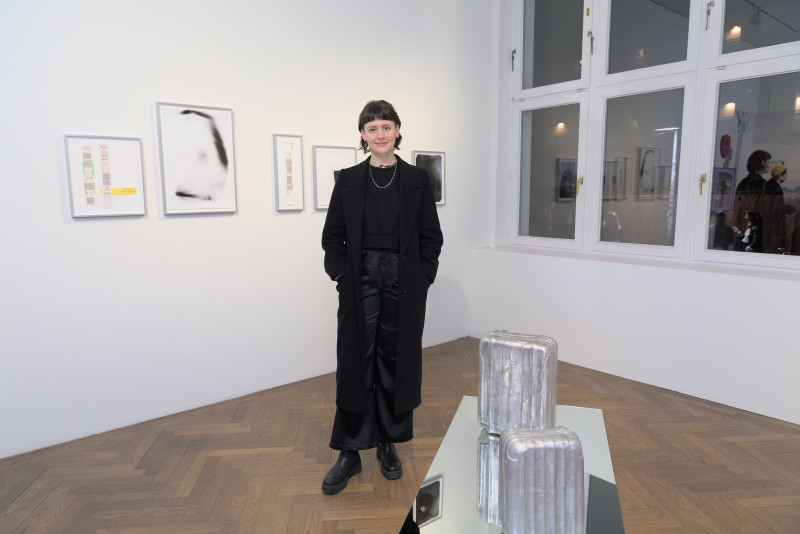 The picture shows the artist in front of her work 